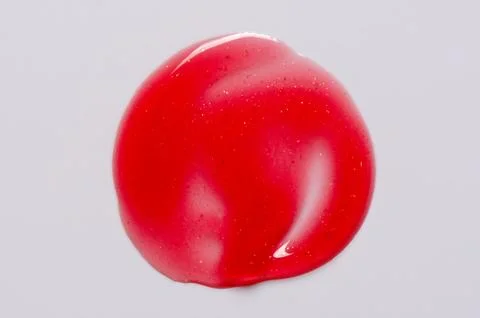 A sample of lip moisturizer on a white background. Oil or lip balm. Stock Photos