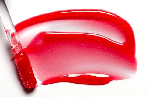 A sample of lip moisturizer on a white background. Oil or lip balm. Stock Photos