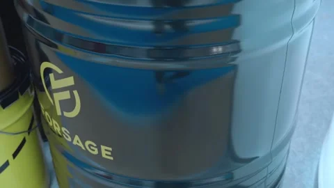A sample of the new motor oil in a 200-litre barrel and various canisters Stock Footage 340628897