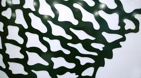 Sample part of Laser cutting of thin black sheet material on white background Stock Photos