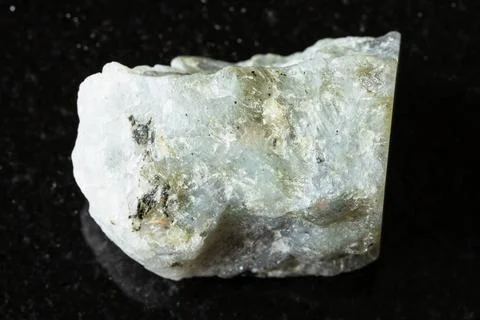 Sample of raw gray labradorite mineral on black Stock Photos