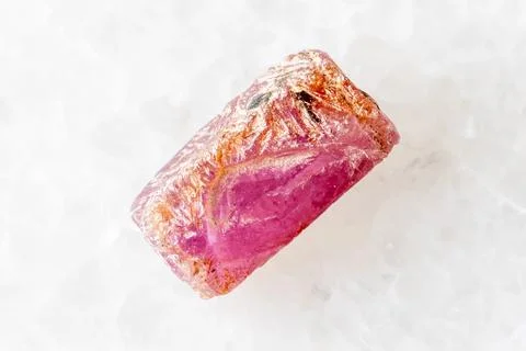Sample of raw pink ruby crystal on white marble Stock Photos