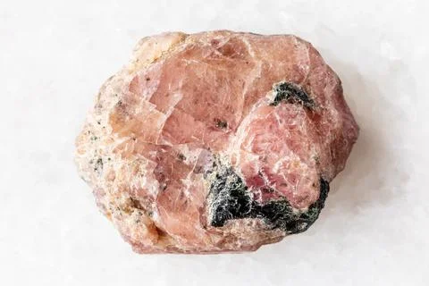 Sample of raw pink ruby mineral on white marble Stock Photos