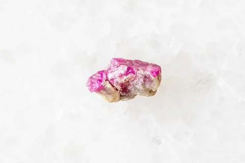 Sample of raw pink ruby mineral on white marble Stock Photos