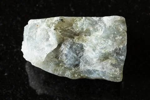 Sample of rough gray labradorite rock on black Stock Photos