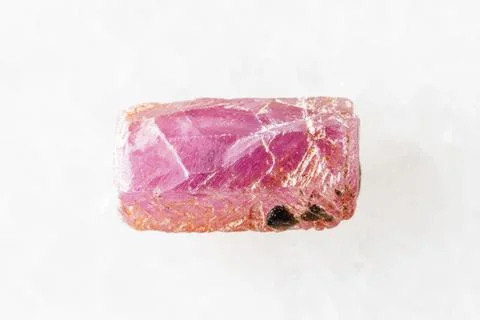 Sample of rough pink ruby crystal on white marble Stock Photos