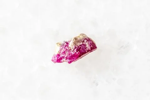 Sample of rough pink ruby mineral on white marble Stock Photos
