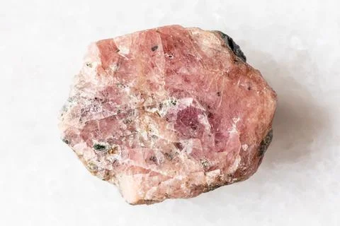 Sample of rough pink ruby mineral on white marble Stock Photos