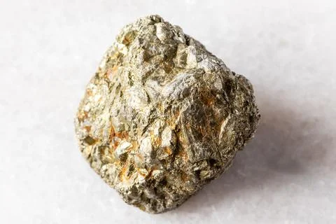 Sample of rough pyrite rock on white marble Stock Photos