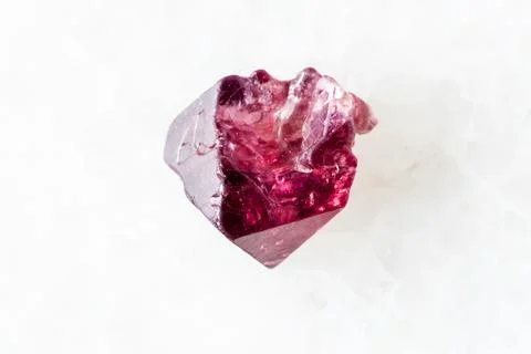 Sample of rough red spinel crystal on white Foto stock
