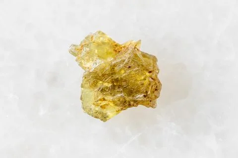 Sample of rough sinhalite mineral on white marble Stock Photos