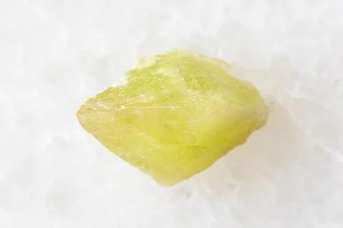 Sample of rough sphene crystal on white marble Stock Photos