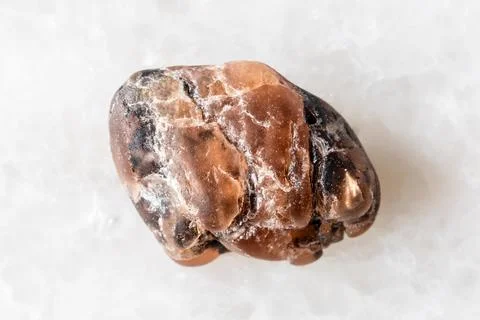 Sample of rough triplite mineral on white marble Stock Photos