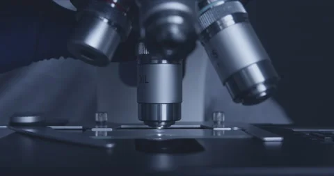 Sample slide and microscope with metal lens at laboratory. 스톡 동영상 144008848