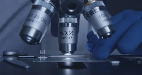Sample slide and microscope with metal lens at laboratory. Stock-Footage 144009474