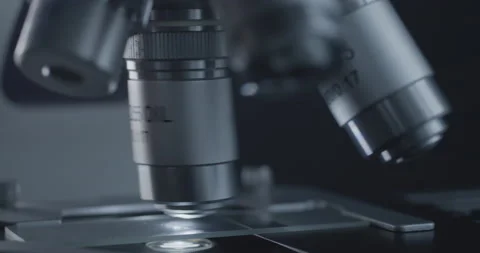 Sample slide and microscope with metal lens at laboratory. 스톡 동영상 144200812