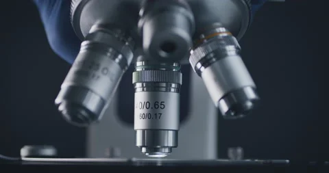 Sample slide and microscope with metal lens at laboratory. 스톡 동영상 144200992