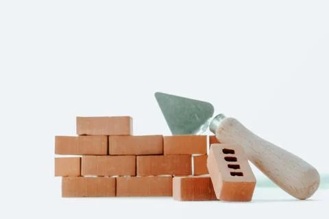 Sample of a small masonry wall made of red brick using a cement mortar tool Stock Photos