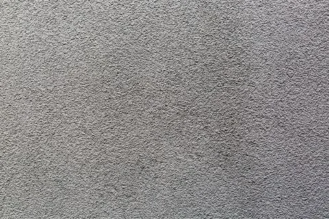 Sample of a texture of gray plaster. Wall finished with a decorative cement.. Stock Photos