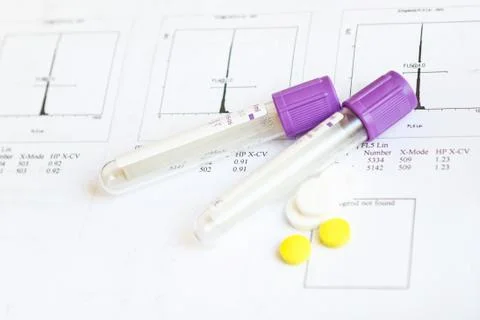 Sample tubes and pills on test results paper - background. Stock-Fotos