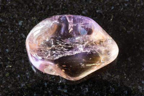Sample of tumbled ametrine gemstone on black Stock Photos