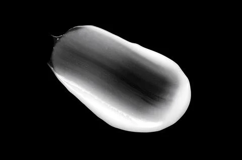 A sample of white body cosmetics on a black background Stock-Fotos