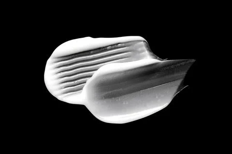 A sample of white body cosmetics on a black background Stock-Fotos