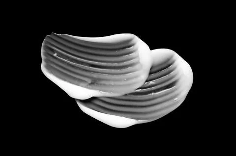 A sample of white body cosmetics on a black background Stock Photos