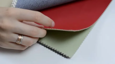 Samples of artificial leather. Women's hands touch the leather for sewing. Stock Footage 157045918