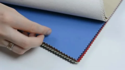 Samples of artificial leather. Women's hands touch the leather for sewing. Stock Footage 157045923