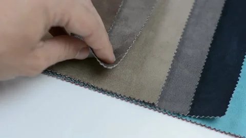 Samples of artificial suede. Women's hands are sorting through samples of suede. Stock Footage 157045862