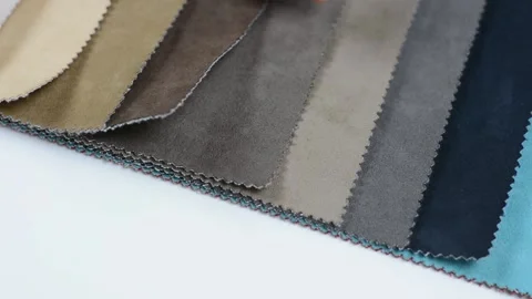 Samples of artificial suede. Women's hands are sorting through samples of suede. Stock Footage 157045865