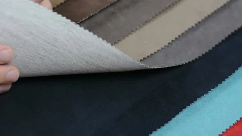 Samples of artificial suede. Women's hands are sorting through samples of suede. Stock Footage 157045867