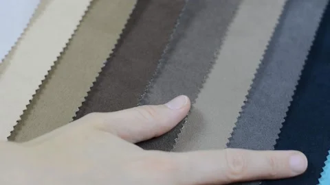 Samples of artificial suede. Women's hands are sorting through samples of suede. Stock Footage 157045885