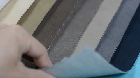 Samples of artificial suede. Women's hands are sorting through samples of suede. Stock Footage 157045890