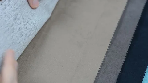 Samples of artificial suede. Women's hands are sorting through samples of suede. Stock Footage 157045906