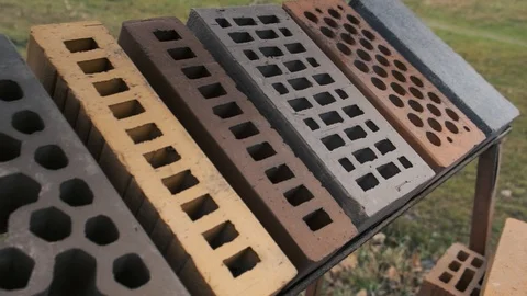 Samples of bricks differ in shape and color displayed in a row at the exhibition Video stock 121874932