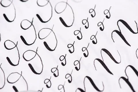 Samples Calligraphy in words.Black ink on lined sheet of paper Stock Photos