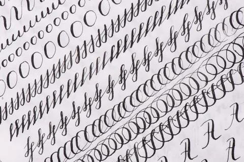 Samples Calligraphy in words.Black ink on lined sheet of paper Stock Photos