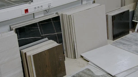 Samples of ceramic tiles are standing on floor in room of control quality Video stock 104991650