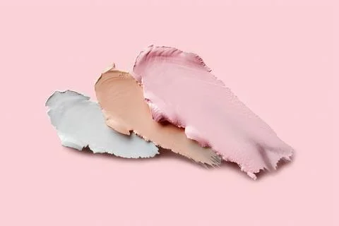 Samples of color correcting concealers Set on pink background. Swatch smears of Stock Photos