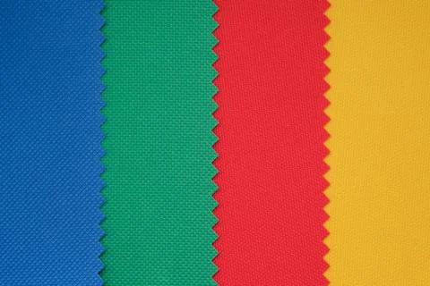 Samples of fabrics in different colors. Blue, green, red piece of fabric with Stock Photos