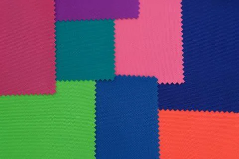 Samples of fabrics in different colors. Blue, green, pink piece of fabric wit Stock Photos