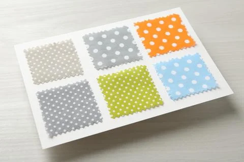 Samples of fabrics with polka dot pattern on light wooden table Stock Photos