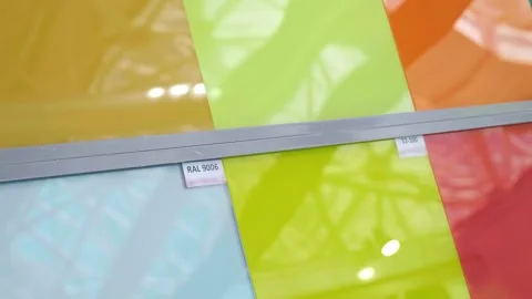 Samples of glass of different colours are presented at the exhibition Stock Footage 333394749