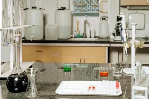 Samples in lab glassware surrounded by lab equipment in hospital laboratory Stock Photos