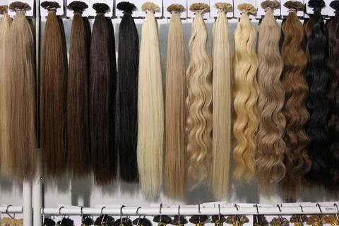Samples of long hair, a large selection from blonde to brunette Stock Photos