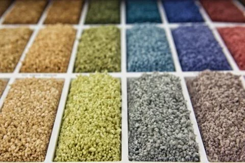 Samples of multi-colored carpets on the shelves Stock Photos