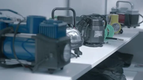 Samples of new 12-volt automotive tire pumps are on display at the exhibition Stock Footage 340628843