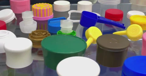 Samples of products for the production of multi-colored plastic caps and bottles Stock Footage 329182507